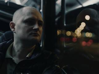 muž hledí ven z okna dopravního prostředku